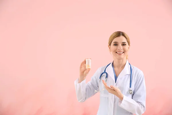 Portrait of beautiful gynecologist on color background — Stock Photo, Image