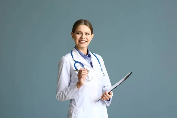 Portrait of young gynecologist on grey background — Stock Photo, Image