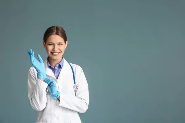 Portrait of young gynecologist on grey background — Stock Photo, Image