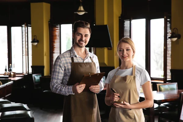 Young waiters in restaurant