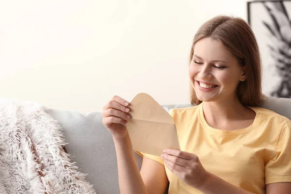 Young woman receiving invitation at home — Stock Photo, Image