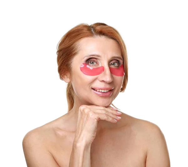 Volwassen vrouw met onder-oog patches op witte achtergrond — Stockfoto