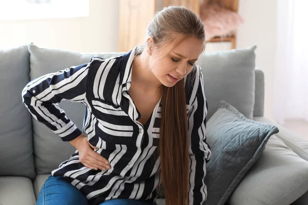 Young woman suffering from stomachache at home — Stock Photo, Image