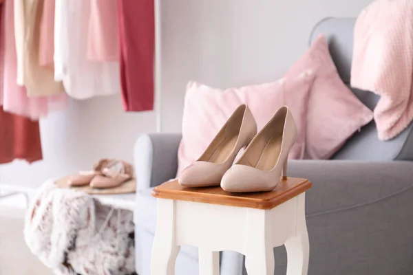 Elegant female high-heels on table in dressing room