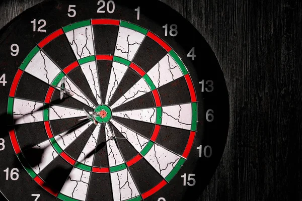 Dartboard on dark wall — Stock Photo, Image