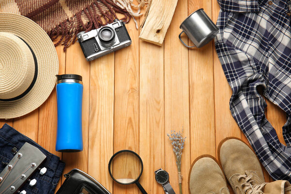 Set of items for tourist on wooden background