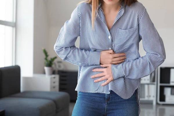 Woman suffering from stomachache at home — Stock Photo, Image