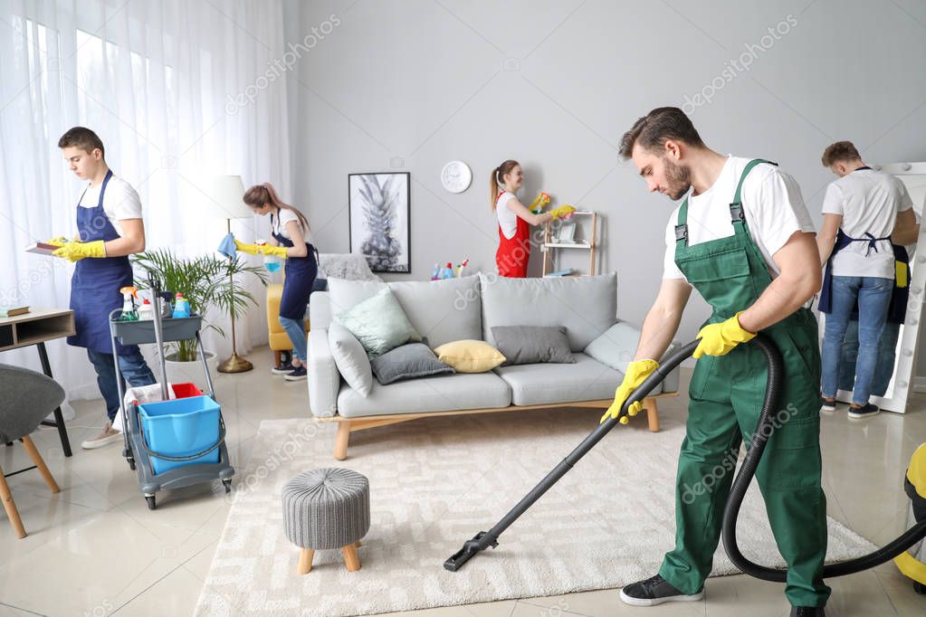 Team of janitors cleaning room