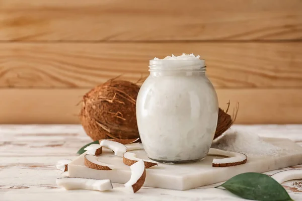 Jar with coconut oil on table — Stock Photo, Image