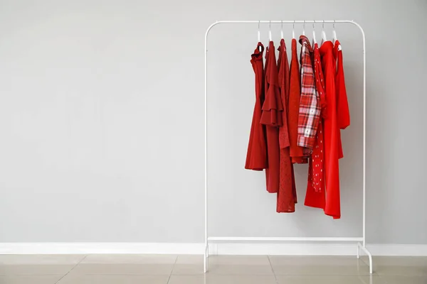 Rack with stylish clothes near grey wall — Stok Foto