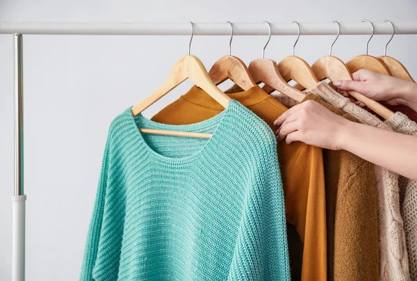 Woman choosing clothes in dressing room — Stock Photo, Image