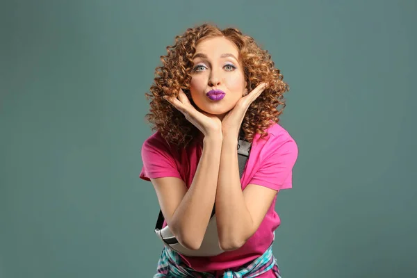 Playful young woman on grey background — Stock Photo, Image