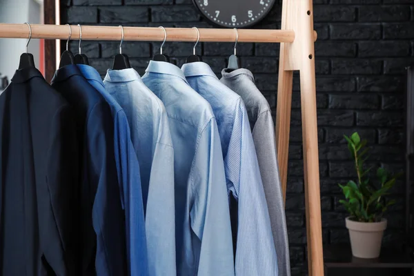 Rack with male clothes in dressing room — Stock Photo, Image
