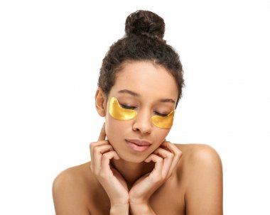 Young African-American woman with under-eye patches on her face against white background clipart
