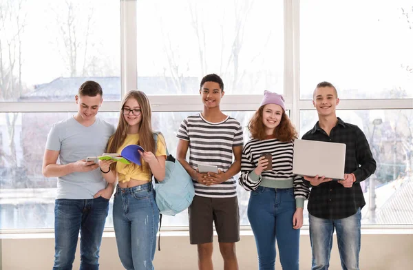 Teenagers with modern devices indoors — Stock Photo, Image