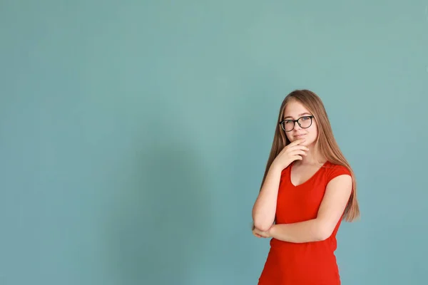 Thoughtful teenage girl on color background — Stock Photo, Image