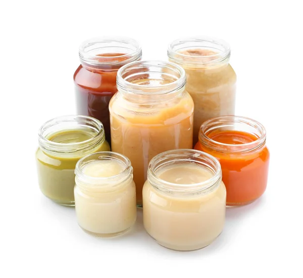 Jars with different healthy baby food on white background — Stock Photo, Image