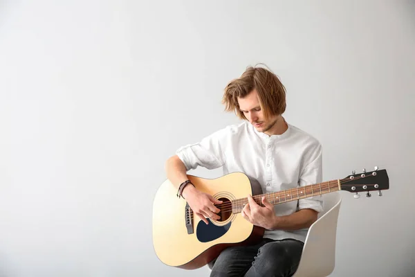 Handsome young man playing guitar on white background — Stock Photo, Image