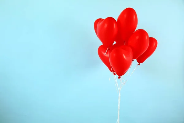 Heart shaped air balloons on color background — Stock Photo, Image