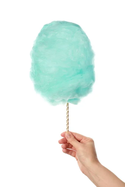 Weibliche Hand mit leckeren Zuckerwatte auf weißem Hintergrund — Stockfoto