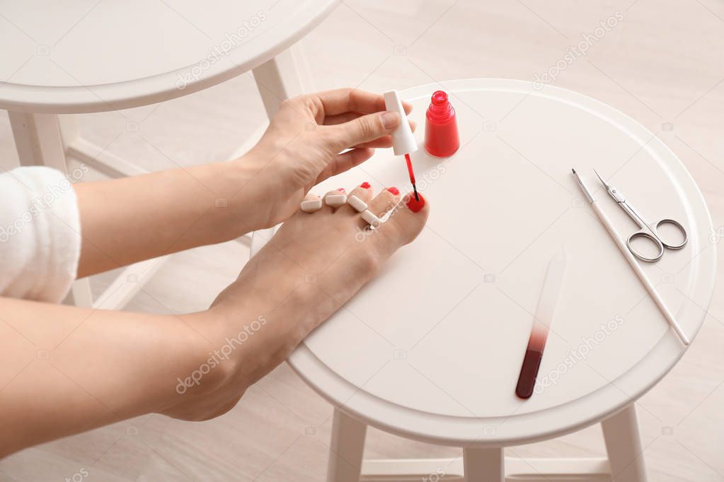 Woman doing pedicure at home