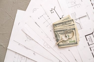 Ev çizimleri, anahtar ve para masada. Gayrimenkul satın alma kavramı