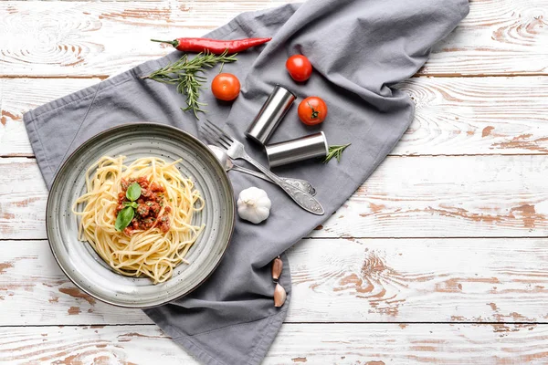 Plate with tasty boiled pasta on wooden table