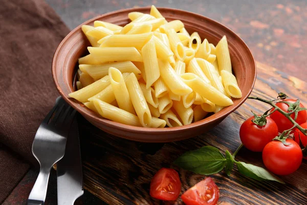 Bowl with tasty boiled pasta on table