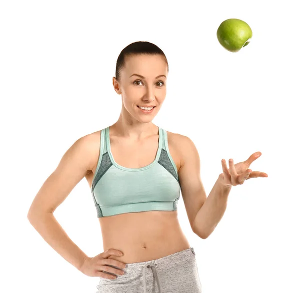 Sporty woman with apple on white background — Stock Photo, Image