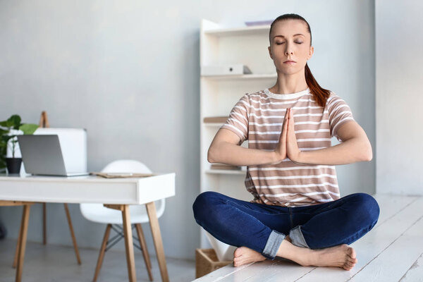 Woman practicing yoga indoors