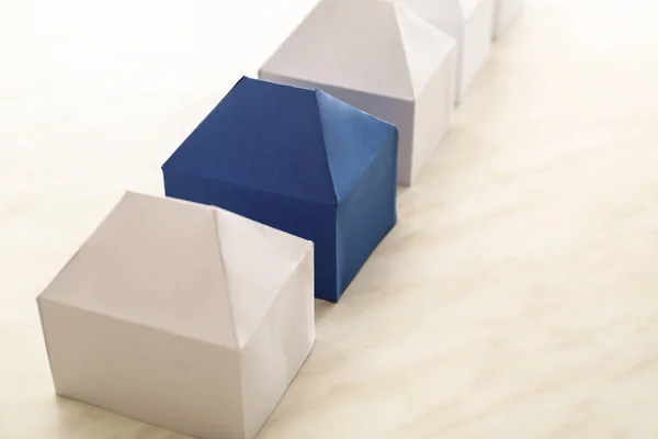 Paper models of houses on table
