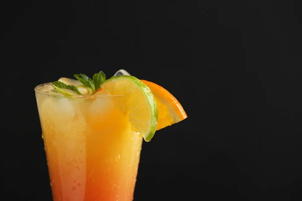 Glass of tasty Tequila Sunrise cocktail on dark background — Stock Photo, Image