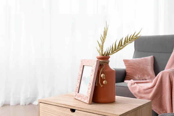 Wooden table with stylish decor in interior of room — Stock Photo, Image