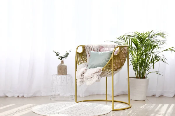 Stylish armchair near light curtains in room — Stock Photo, Image
