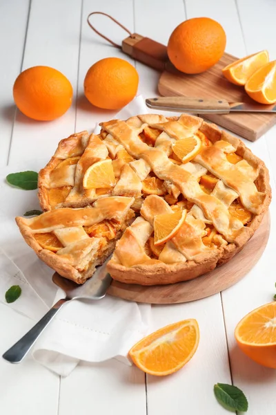 Tasty orange pie on table