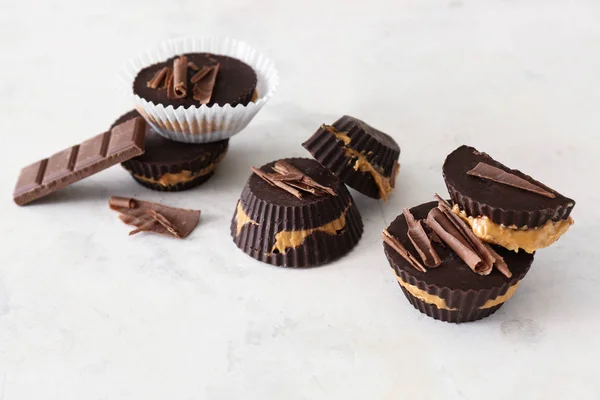 Tasty chocolate peanut butter cups on light background — Stock Photo, Image