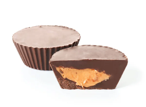 Tasty chocolate peanut butter cups on white background — Stock Photo, Image