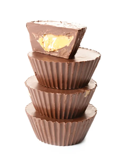 Tasty chocolate peanut butter cups on white background