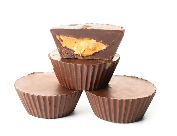 Tasty chocolate peanut butter cups on white background — Stock Photo, Image