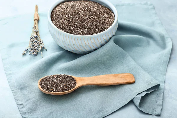 Bowl and spoon with chia seeds on table — Stock Photo, Image