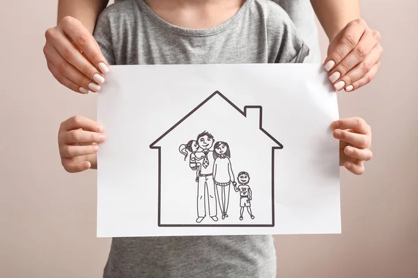 Woman and child with drawing of family. Concept of adoption — Stock Photo, Image