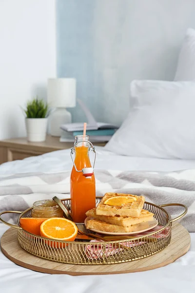 Tray with tasty breakfast on bed — Stock Photo, Image