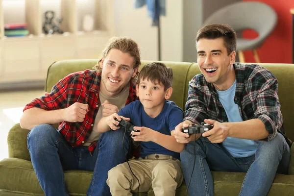 Gay couple with adopted child playing video game at home — Stock Photo, Image