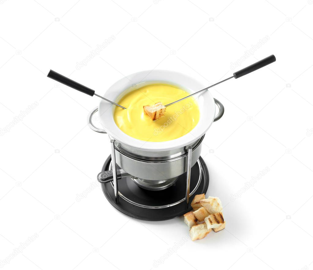 Fondue pot with melted cheese and bread on white background