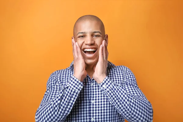 Excited African-American man on color background — Stock Photo, Image