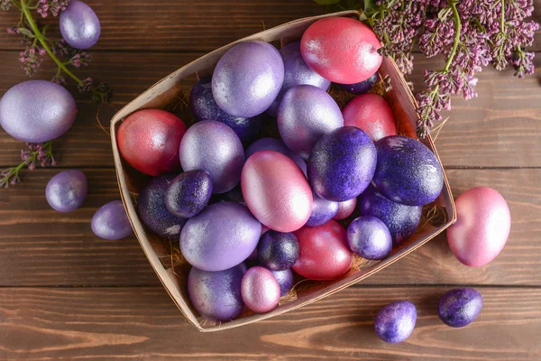 Box with beautiful Easter eggs on wooden background — Stock Photo, Image