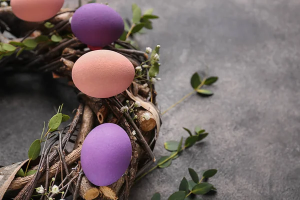 Corona con hermosos huevos de Pascua sobre fondo gris —  Fotos de Stock