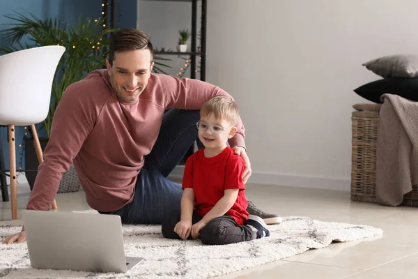 Young father with little son watching cartoons at home — Stock Photo, Image