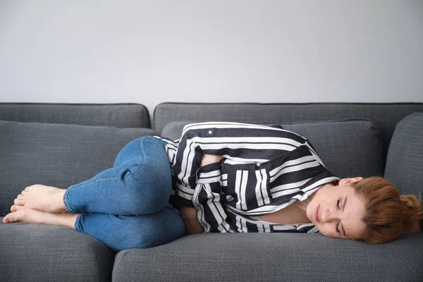 Beautiful woman suffering from abdominal pain at home — Stock Photo, Image