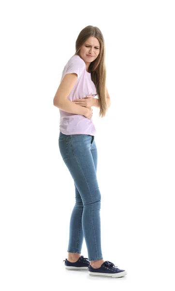 Young woman suffering from abdominal pain on white background — Stock Photo, Image